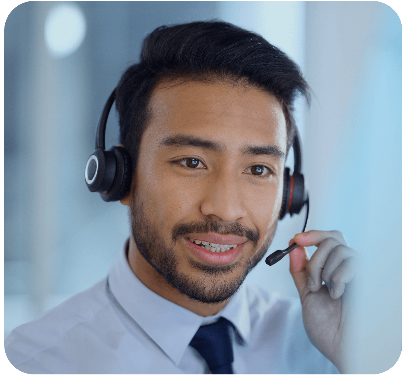 A remote customer support agent with a headset, smiling.